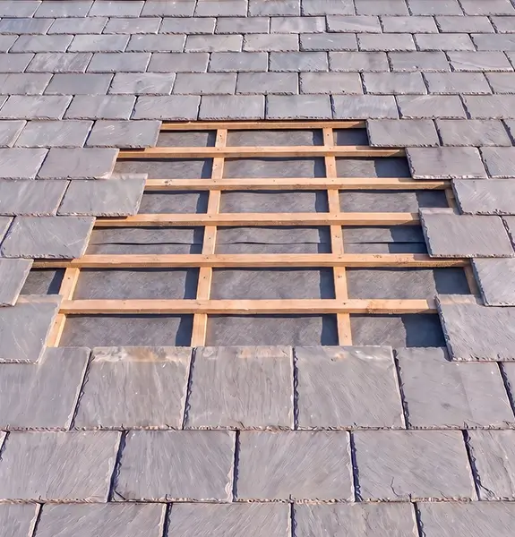 Completed grey tiled roof with repaired chimney